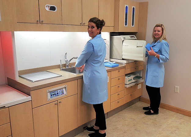 Two dental team members in lab area