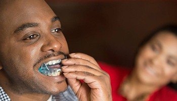 Man placing oral appliance